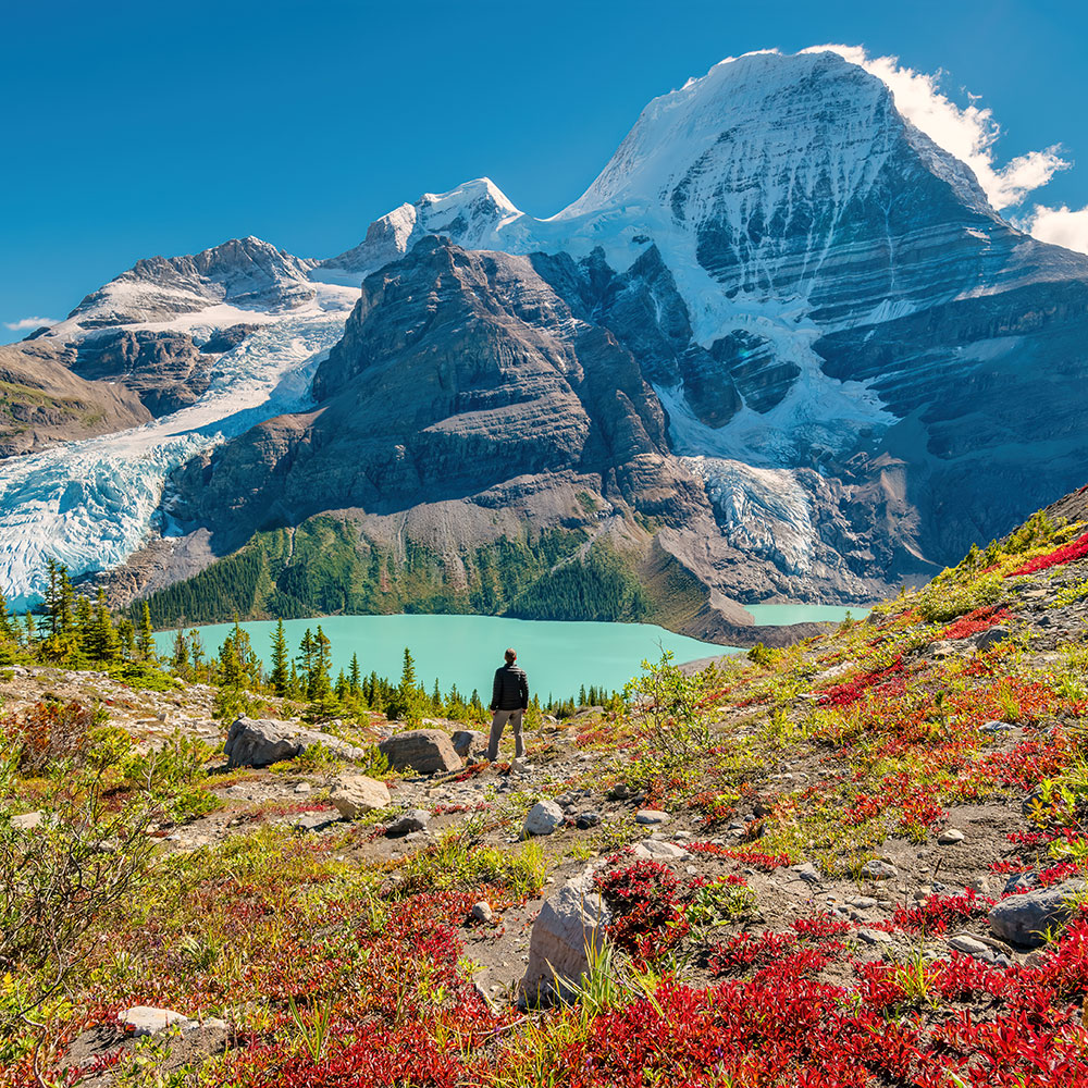 Hiker admires view of Mount Robson from above Berg Lake, Mount Robson Provincial Park, British Columbia, Canadian Rockies on a sunny afternoon. © istockphoto by benedek.